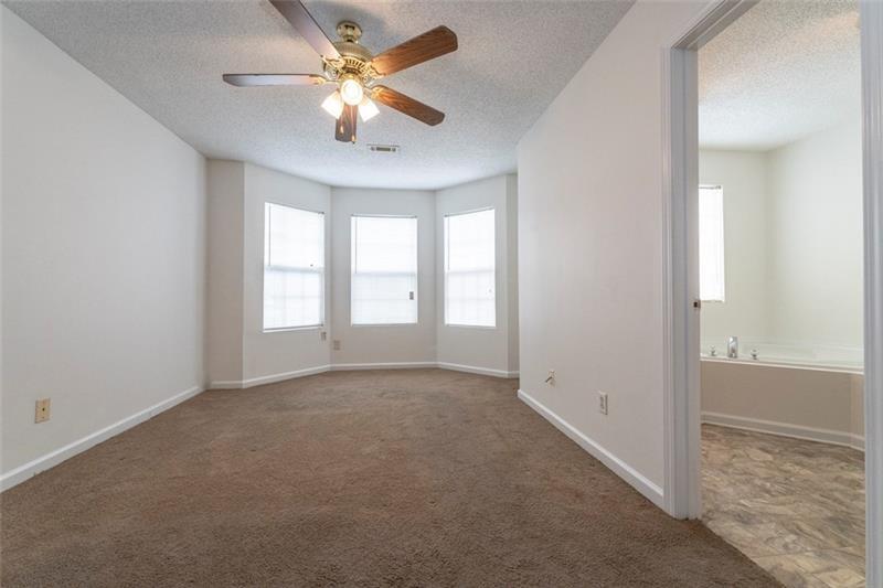 6045 Capitol Knoll Fairburn, GA 30213 - Photo 19 of 37 an empty room with windows and fan