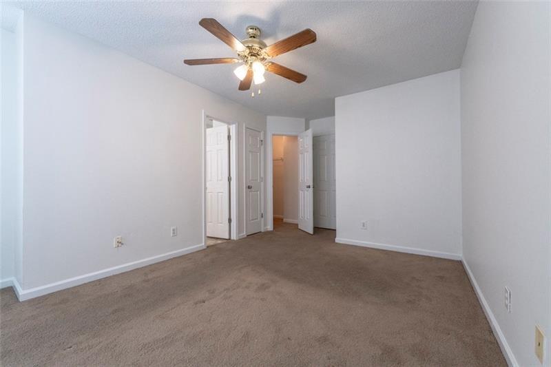 6045 Capitol Knoll Fairburn, GA 30213 - Photo 20 of 37 an empty room with closet and a ceiling fan