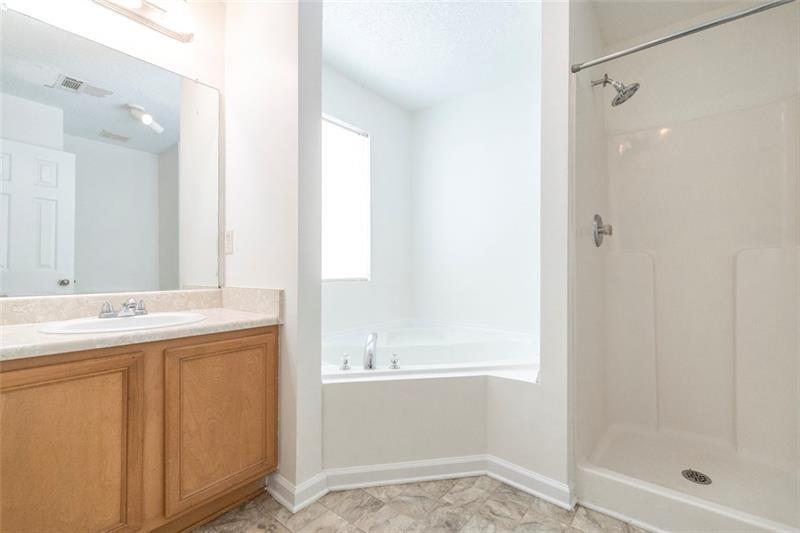6045 Capitol Knoll Fairburn, GA 30213 - Photo 22 of 37 a bathroom with a sink and a mirror
