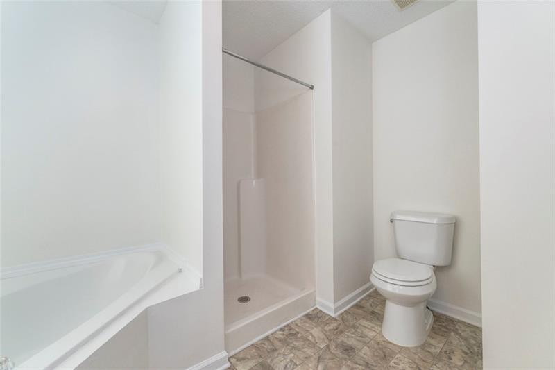 6045 Capitol Knoll Fairburn, GA 30213 - Photo 23 of 37 a bathroom with a toilet and a shower