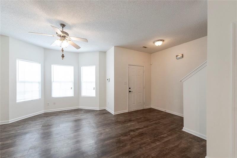 6045 Capitol Knoll Fairburn, GA 30213 - Photo 3 of 37 a view of empty room with wooden floor and fan