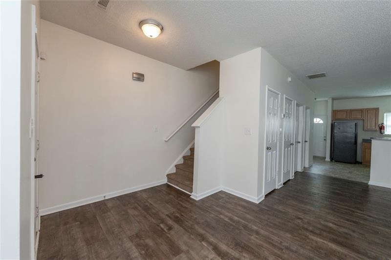 6045 Capitol Knoll Fairburn, GA 30213 - Photo 5 of 37 a view of a hallway with wooden floor and stairs