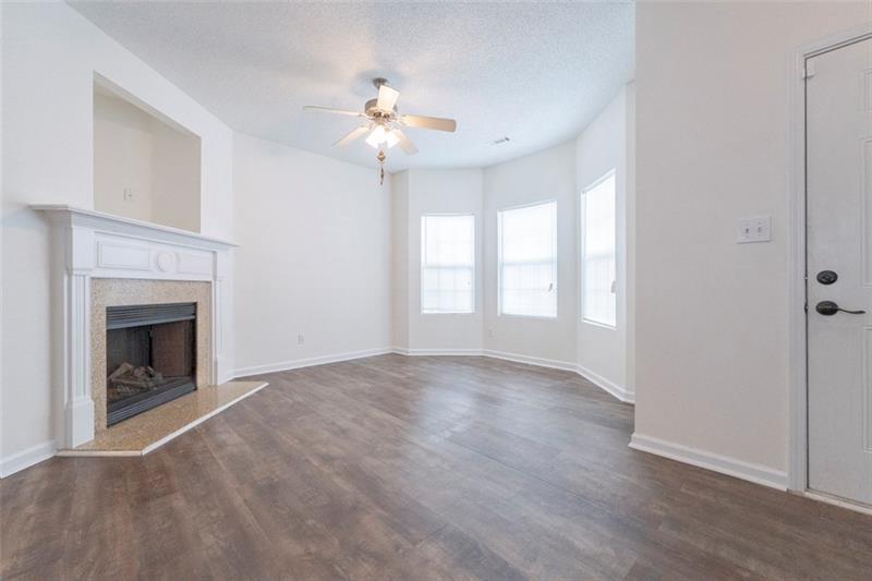 6045 Capitol Knoll Fairburn, GA 30213 - Photo 6 of 37 a view of an empty room with chandelier fan and fire place