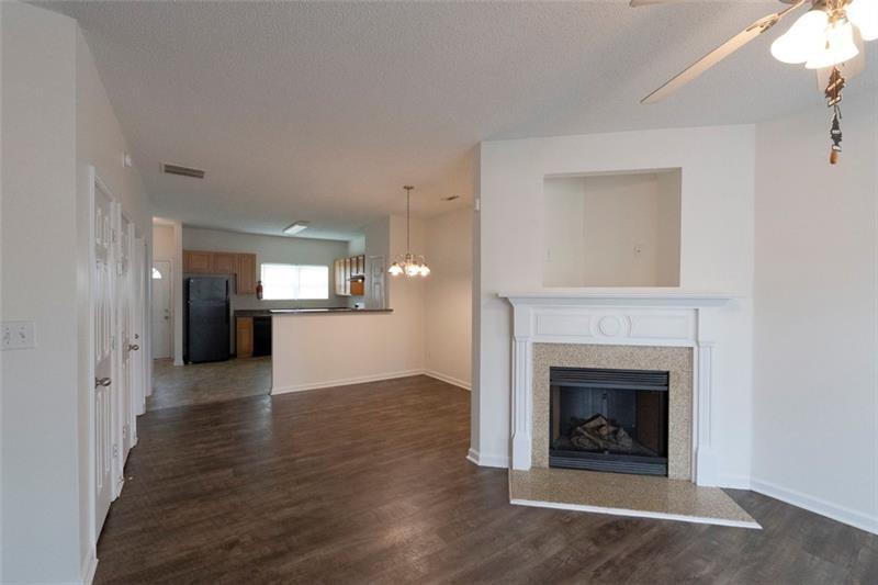 6045 Capitol Knoll Fairburn, GA 30213 - Photo 7 of 37 a view of a hallway with wooden floor and a fireplace