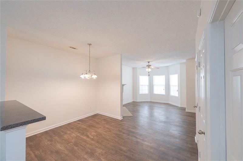 6045 Capitol Knoll Fairburn, GA 30213 - Photo 8 of 37 a view of empty room with wooden floor and fan