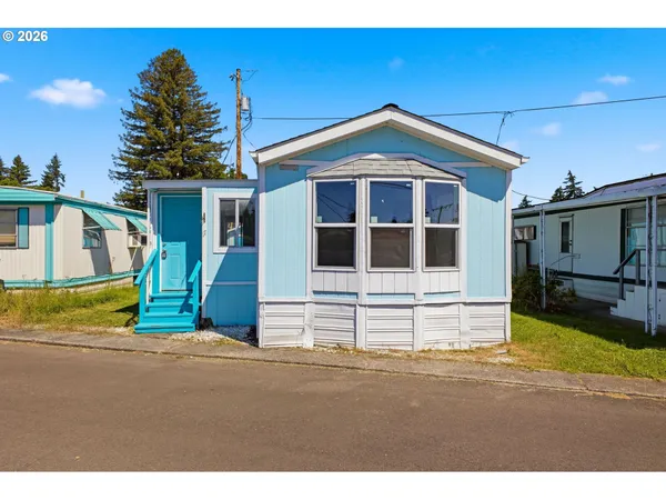 a view of front of house with a yard
