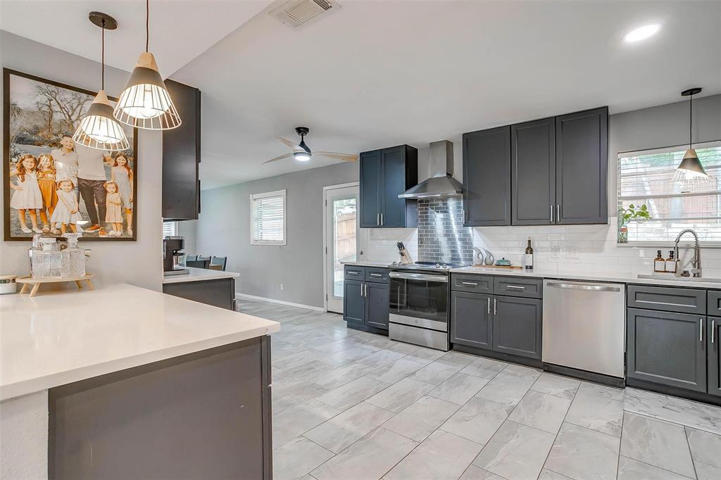 6609 Genoa Road Fort Worth, TX 76116 - Photo 15 of 39 Kitchen with stainless steel appliances, wall chimney exhaust hood, light countertops, backsplash, and recessed lighting