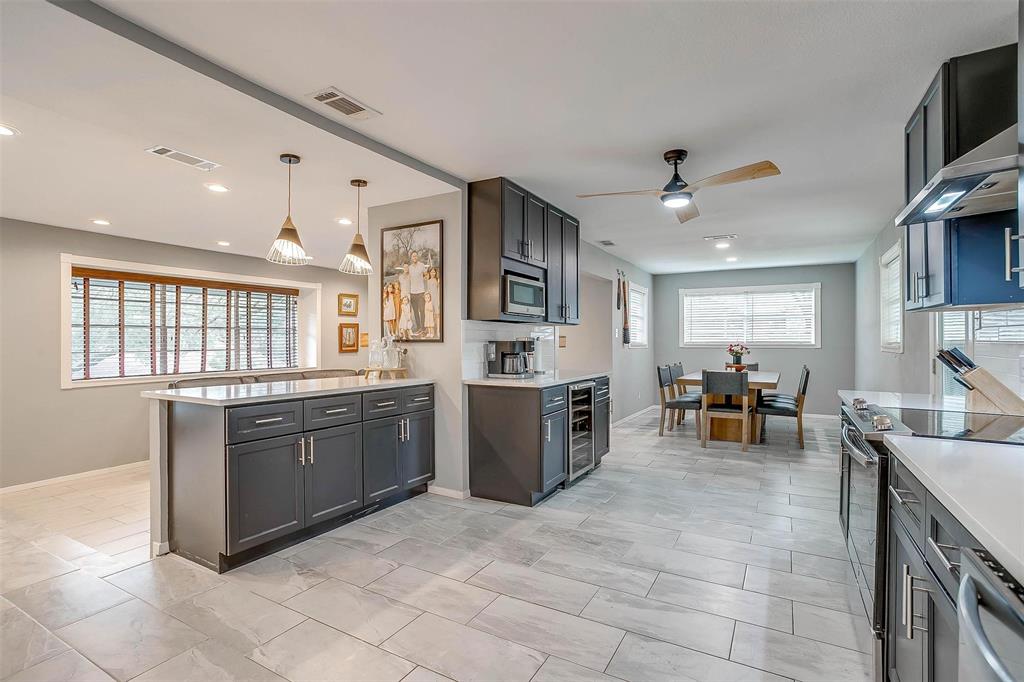 6609 Genoa Road Fort Worth, TX 76116 - Photo 16 of 39 Kitchen with range with electric stovetop, stainless steel microwave, a ceiling fan, light countertops, and dishwasher