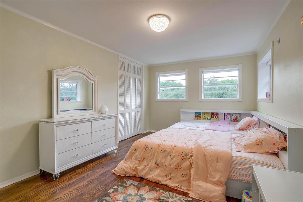 6609 Genoa Road Fort Worth, TX 76116 - Photo 27 of 39 Bedroom featuring dark wood-type flooring, crown molding, and a closet