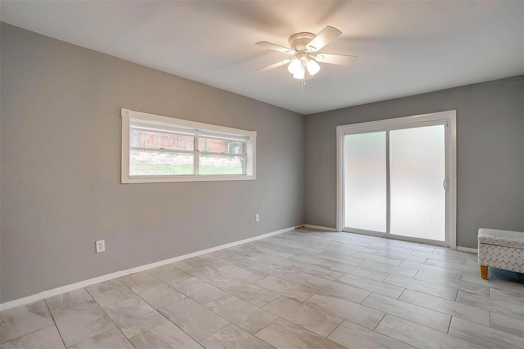 6609 Genoa Road Fort Worth, TX 76116 - Photo 32 of 39 Spare room featuring a ceiling fan and baseboards