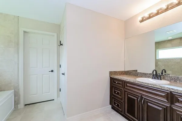 a bathroom with a sink a vanity and a mirror