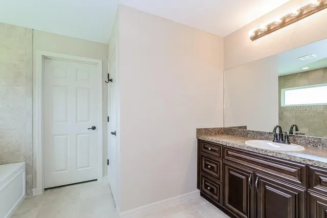 a bathroom with a sink a vanity and a mirror