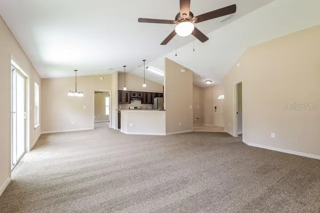 a view of a kitchen with a sink and a refrigerator