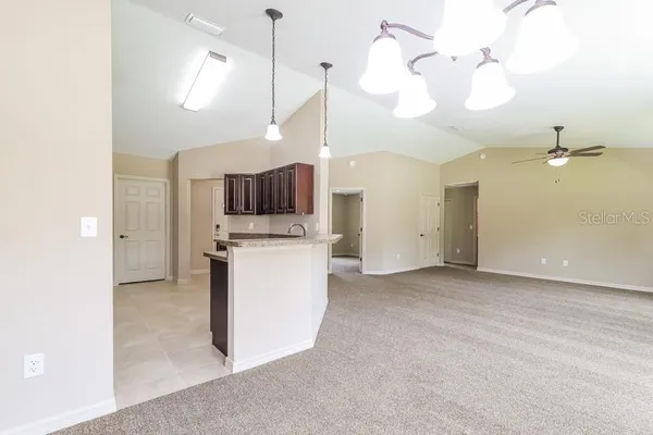a view of a kitchen with a sink and dishwasher a refrigerator with wooden floor