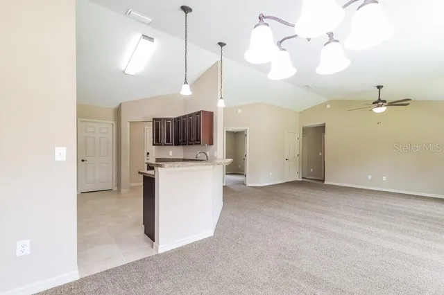 a view of a kitchen with a sink and dishwasher a refrigerator with wooden floor