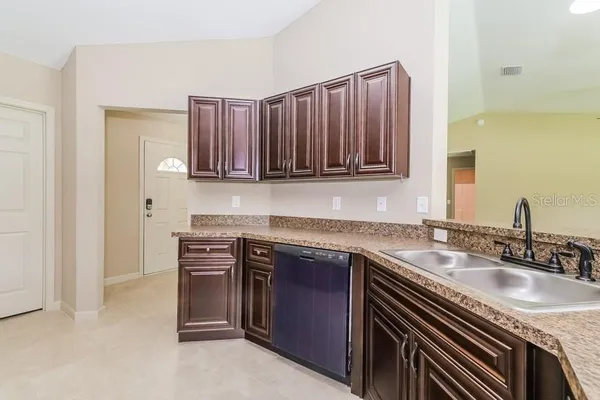 a kitchen with stainless steel appliances granite countertop a sink stove and cabinets
