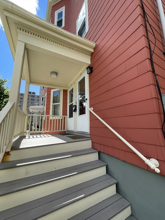 39 Calvin Street, Unit 2 Somerville, MA 02143 - Photo 9 of 11 a view of entryway and hall with wooden floor