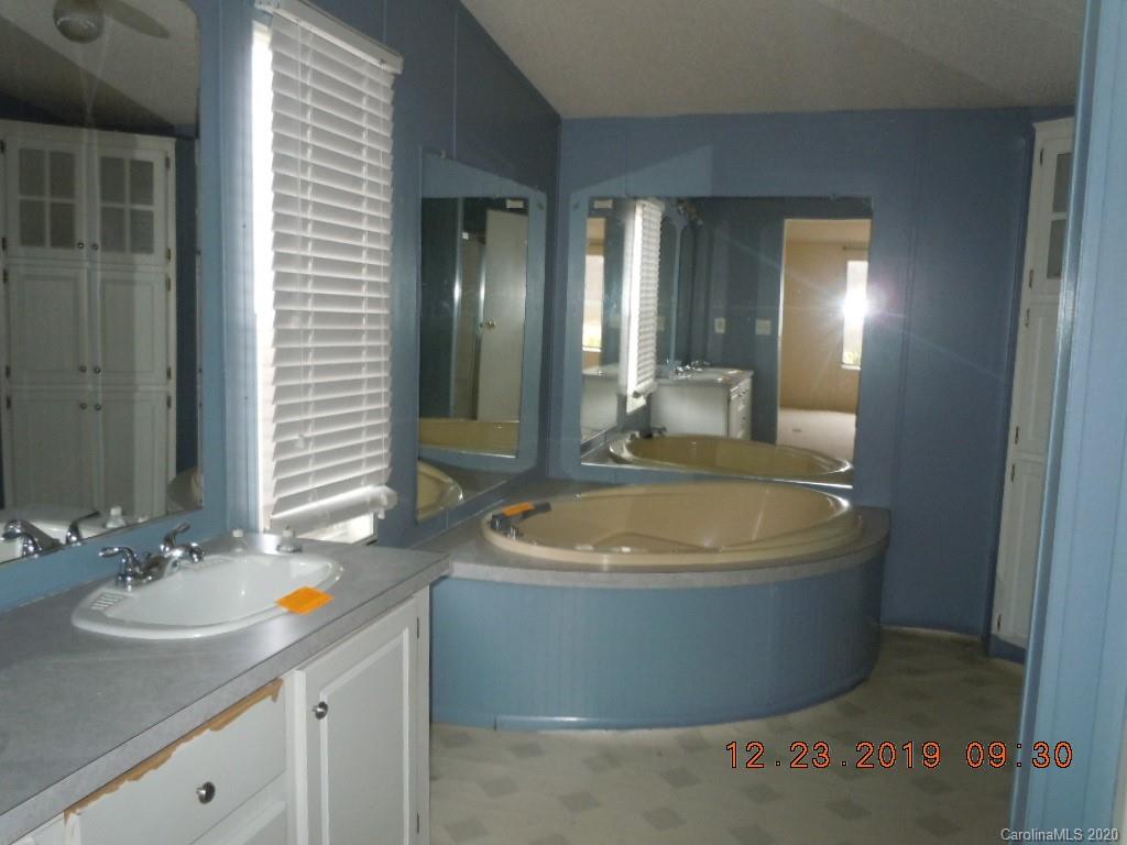 135 Austin Road Clyde, NC 28721 - Photo 8 of 9 a bathroom with a tub sink and mirror