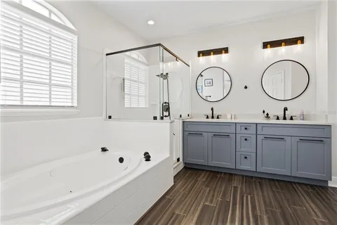 a spacious bathroom with a granite countertop sink mirror toilet and bathtub