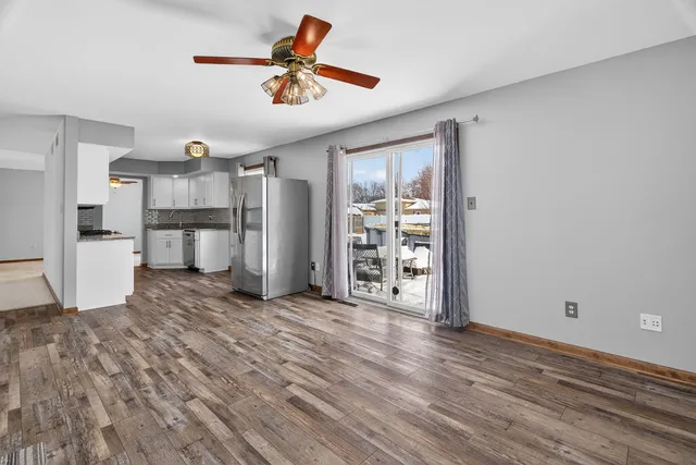 a view of a kitchen with wooden floor and a window