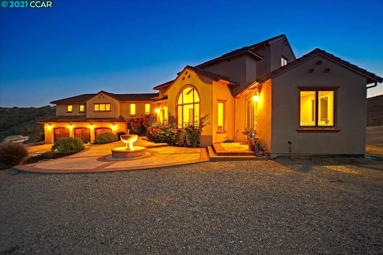 a view of an house with backyard space and balcony