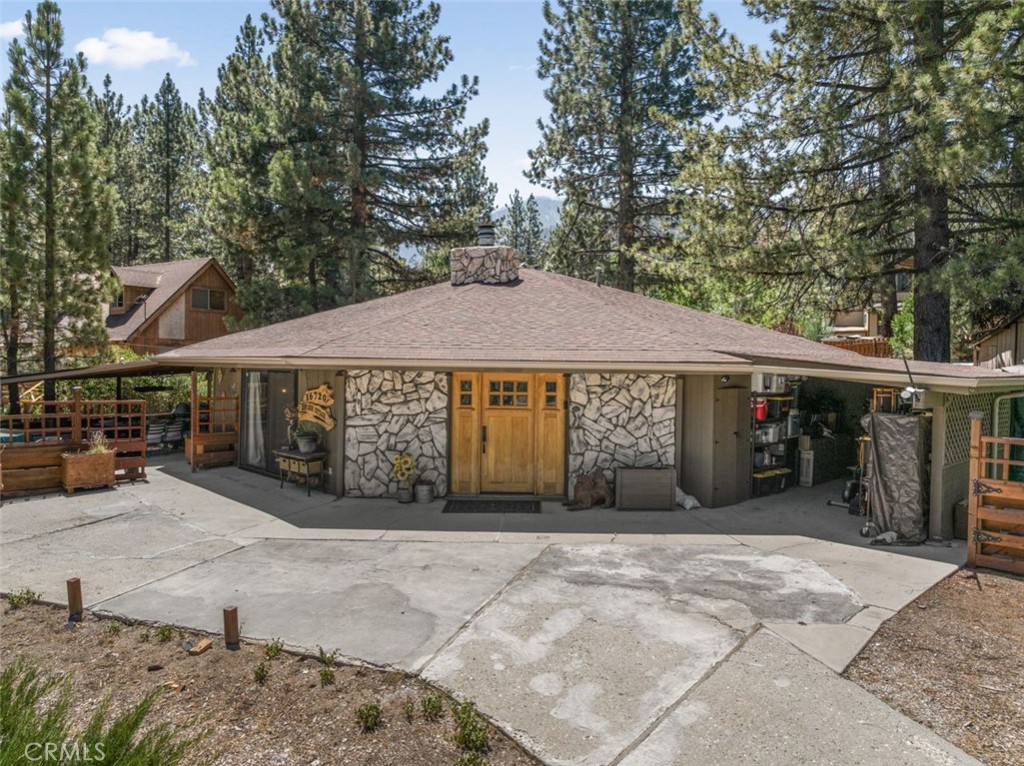 16720 Mil Potrero Frontage Road Pine Mountain Club, CA 93222 - Photo 1 of 39 a front view of a house with a yard and garage