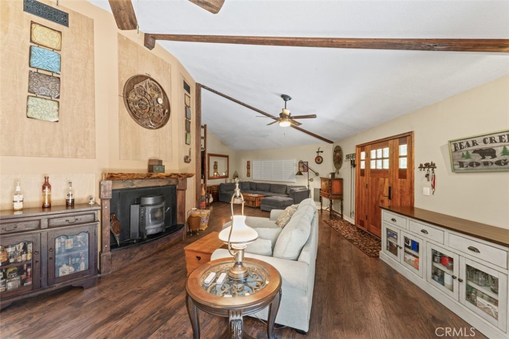 16720 Mil Potrero Frontage Road Pine Mountain Club, CA 93222 - Photo 12 of 39 a living room with furniture a flat screen tv and a clock