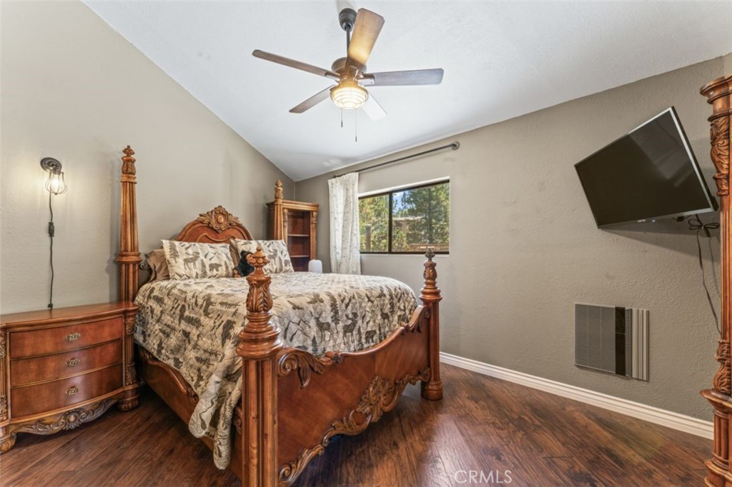 16720 Mil Potrero Frontage Road Pine Mountain Club, CA 93222 - Photo 16 of 39 a bed sitting in a bedroom next to a window with a flat screen tv