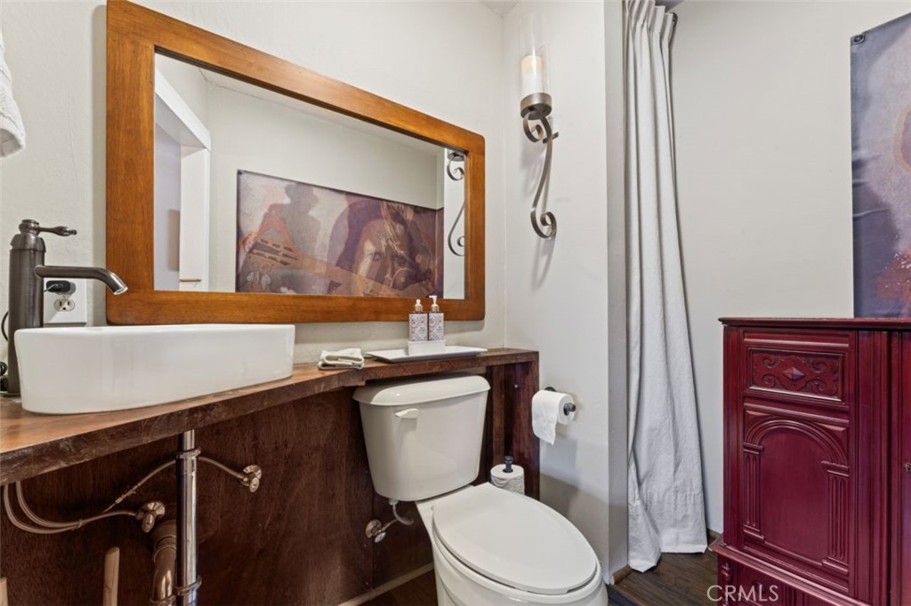 16720 Mil Potrero Frontage Road Pine Mountain Club, CA 93222 - Photo 19 of 39 a bathroom with a toilet a sink and mirror