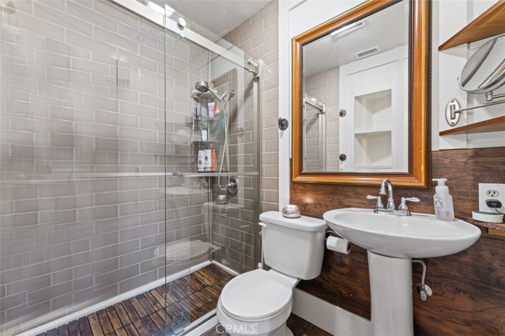 16720 Mil Potrero Frontage Road Pine Mountain Club, CA 93222 - Photo 22 of 39 a bathroom with a sink a toilet and shower