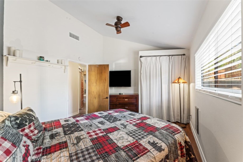 16720 Mil Potrero Frontage Road Pine Mountain Club, CA 93222 - Photo 25 of 39 a bedroom with a bed and a flat tv screen on dresser