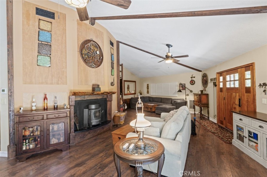 16720 Mil Potrero Frontage Road Pine Mountain Club, CA 93222 - Photo 4 of 39 a living room with furniture a clock on wall and a clock