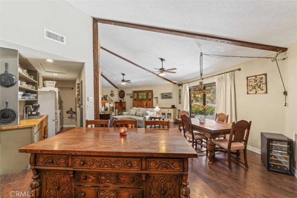 16720 Mil Potrero Frontage Road Pine Mountain Club, CA 93222 - Photo 9 of 39 a dining hall with stainless steel appliances granite countertop a dining table and chairs with wooden floor