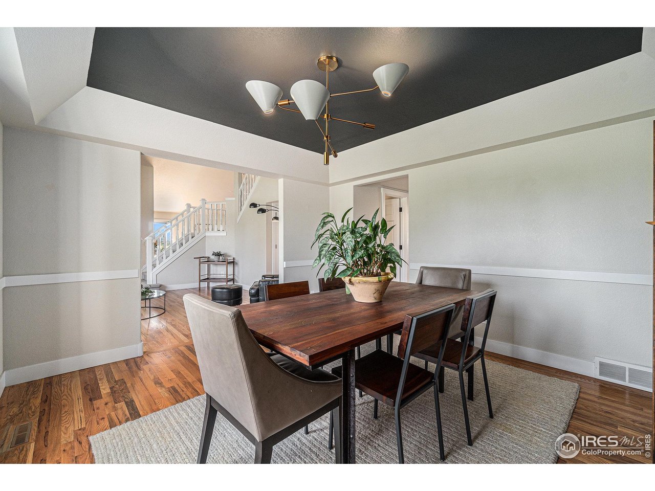 4615 Kitchell Way Fort Collins, CO 80524 - Photo 14 of 41 a view of a dining room with furniture and wooden floor