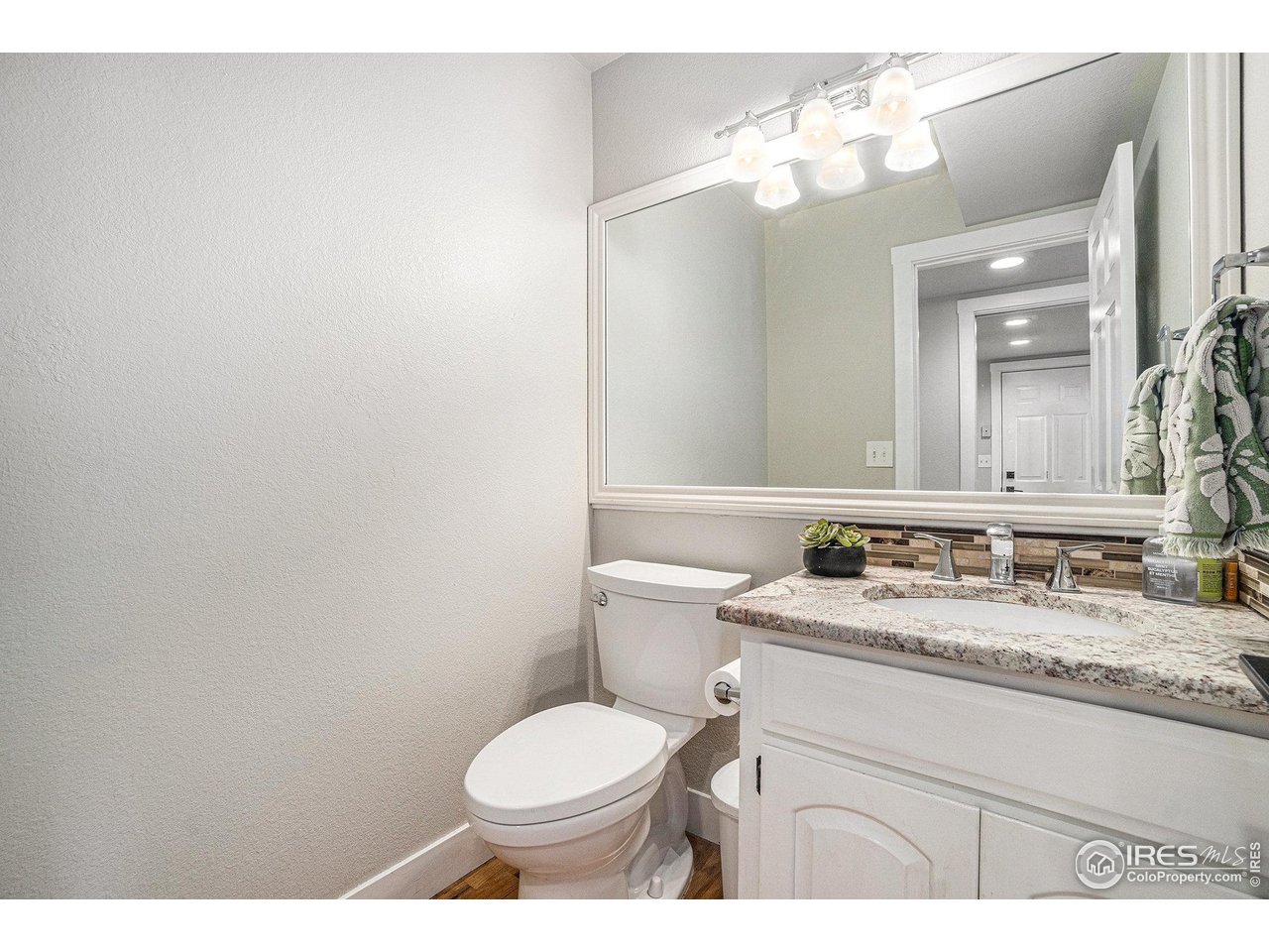 4615 Kitchell Way Fort Collins, CO 80524 - Photo 17 of 41 a bathroom with a granite countertop sink mirror vanity and toilet