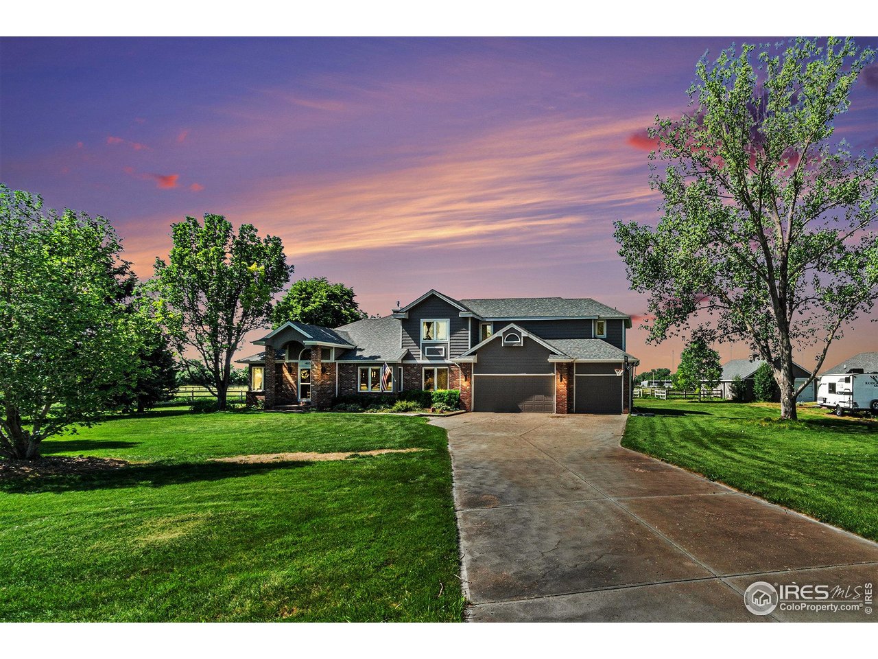 4615 Kitchell Way Fort Collins, CO 80524 - Photo 2 of 41 a front view of a house with a yard and garage