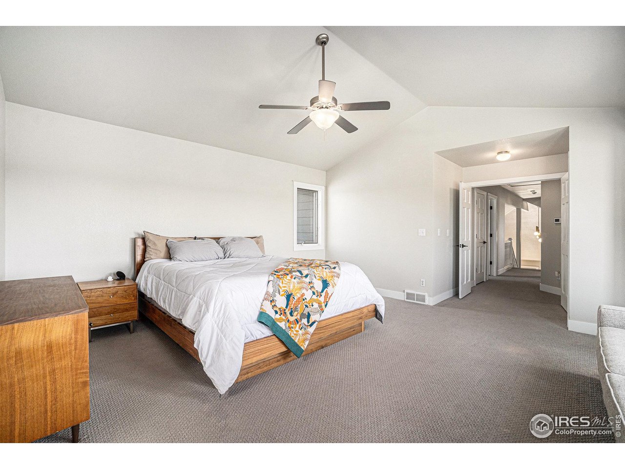 4615 Kitchell Way Fort Collins, CO 80524 - Photo 21 of 41 a spacious bedroom with a bed and a chandelier