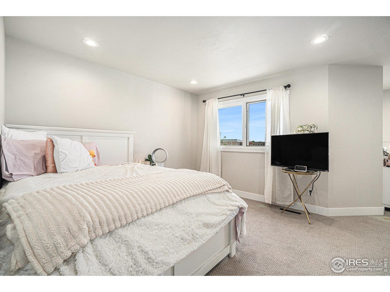 4615 Kitchell Way Fort Collins, CO 80524 - Photo 22 of 41 a bedroom with a bed and a flat screen tv