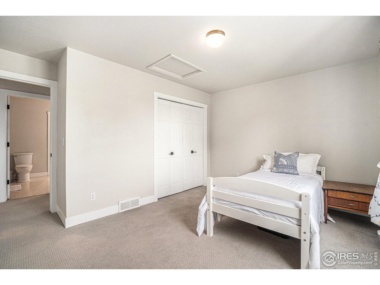 4615 Kitchell Way Fort Collins, CO 80524 - Photo 24 of 41 a bedroom with a bed and a chair