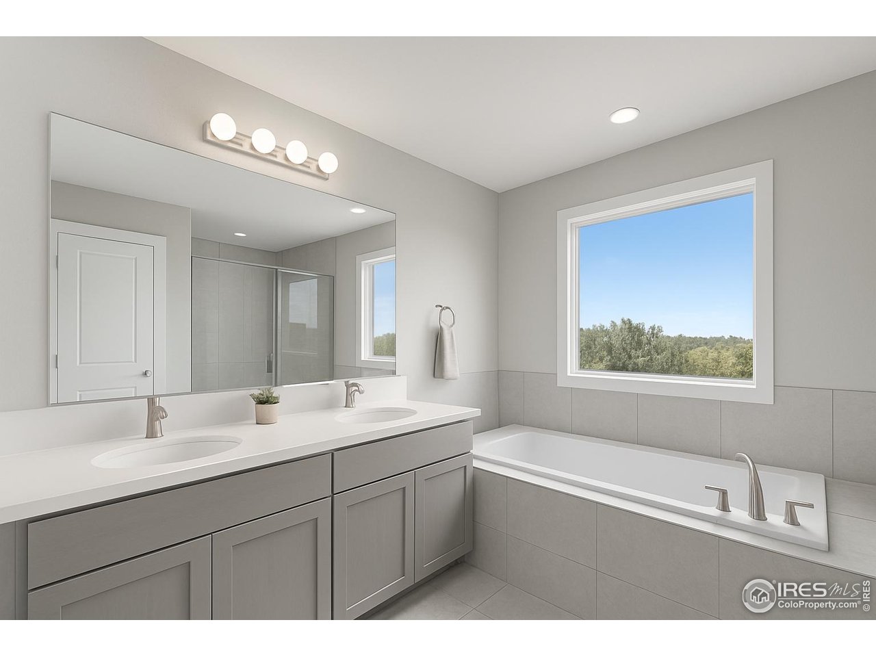 4615 Kitchell Way Fort Collins, CO 80524 - Photo 37 of 41 a bathroom with a sink a large mirror and a bathtub