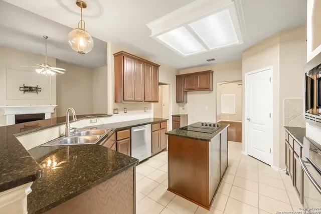 a kitchen with granite countertop a stove and cabinets