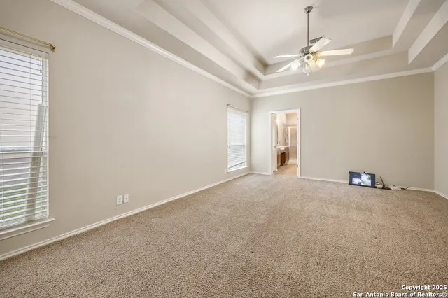 en empty room with windows and fan