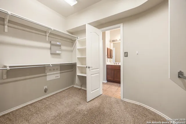 a view of cabinets and utility room with closet
