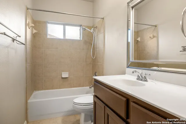 a bathroom with a sink a toilet a shower and a mirror