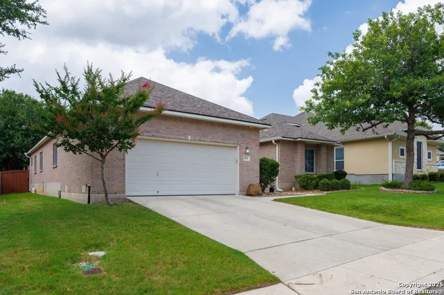a front view of house with yard and trees