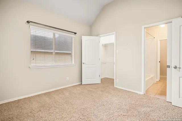 an empty room with windows and closet