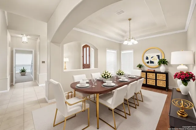 a view of a dining room with furniture and a chandelier