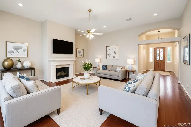 a living room with furniture a fireplace and a flat screen tv