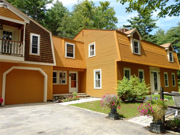 338 Taylor Road Ashby, MA 01431 - Photo 1 of 21 a front view of a house with a yard and outdoor seating