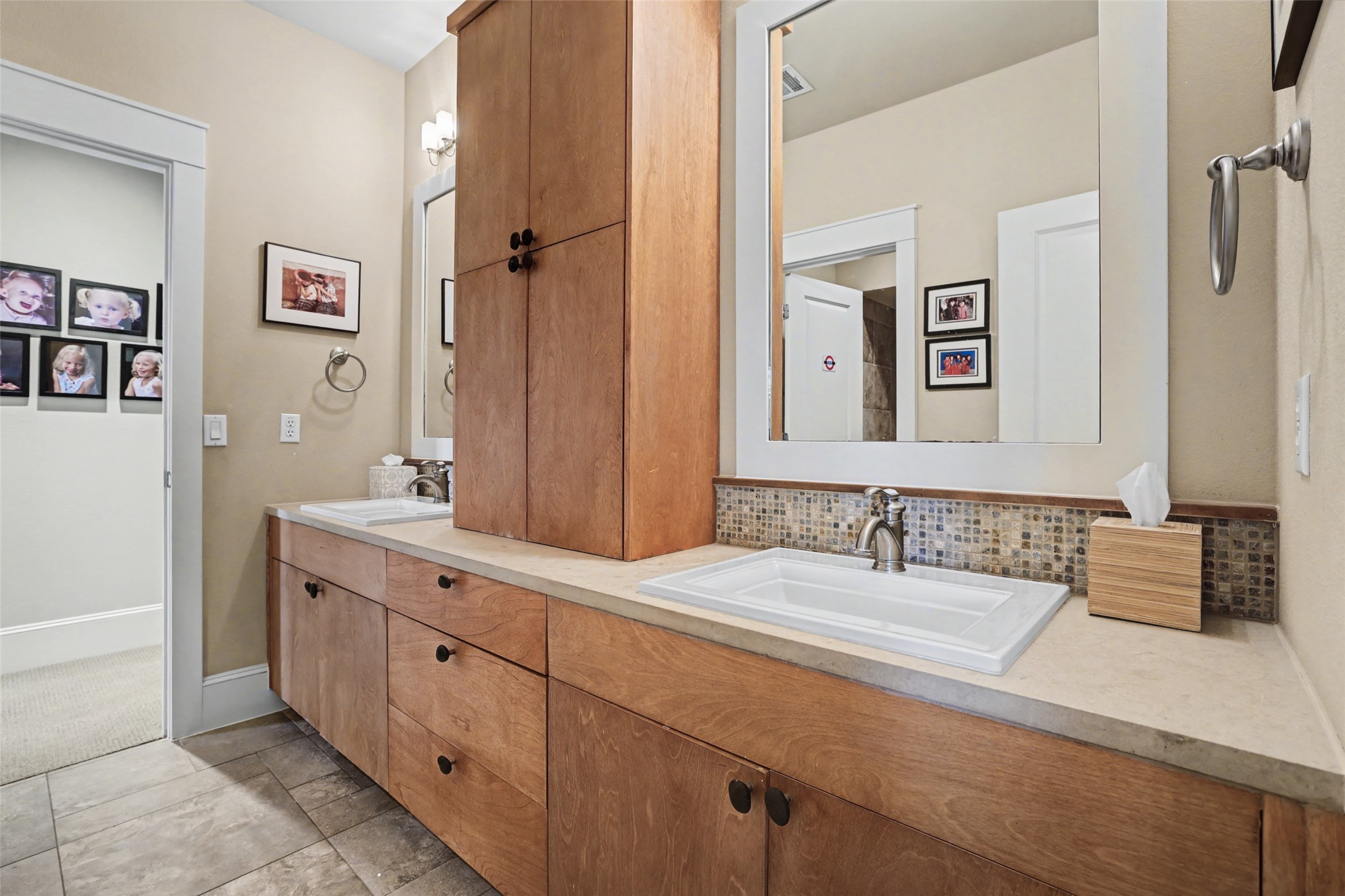 816 Stonewall Ridge Lane Austin, TX 78746 - Photo 26 of 32 Jack and Jill bathroom with double vanity, ample storage and contemporary fixtures.